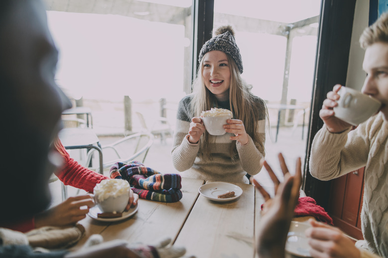 Friends Socialise In Winter Cafe