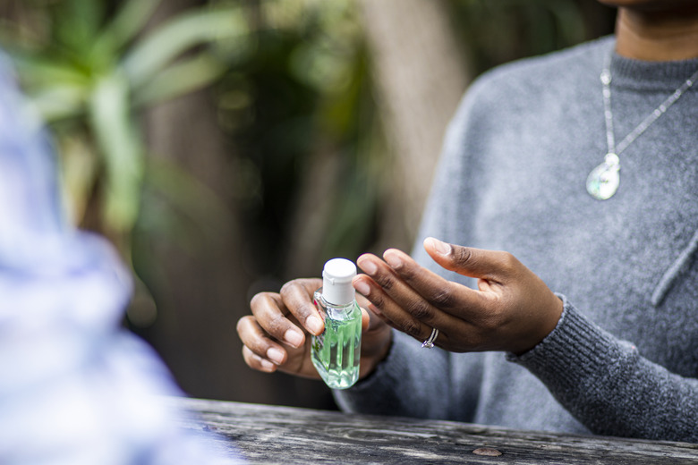 Black Woman Using Hand Sanitizer to Wash Hands