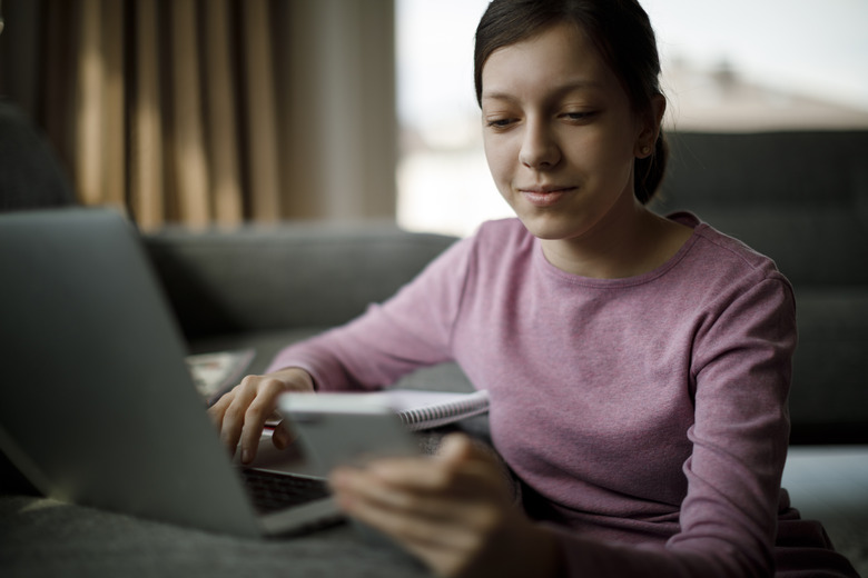 Teenage girl studying at home during COVID-19 pandemic