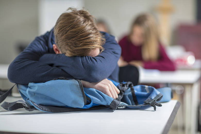 Teenage boy sleeping in class