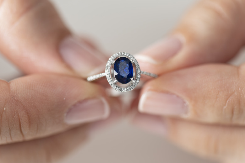 Woman Holding a Blue sapphire