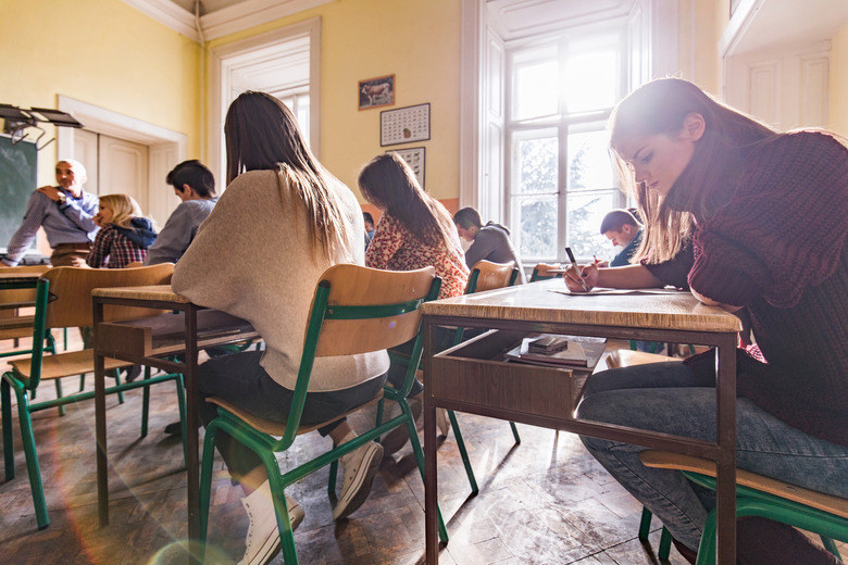 High school students writing a test in the classroom.