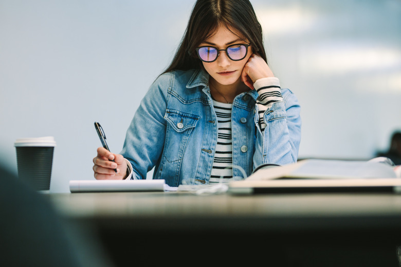 Woman student studying at college library