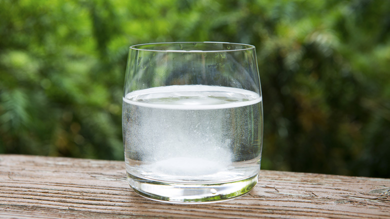 A glass of water with effervescent tablet