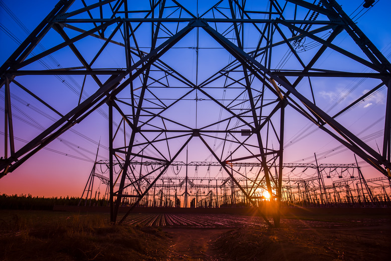 The silhouette of the evening electricity transmission pylon