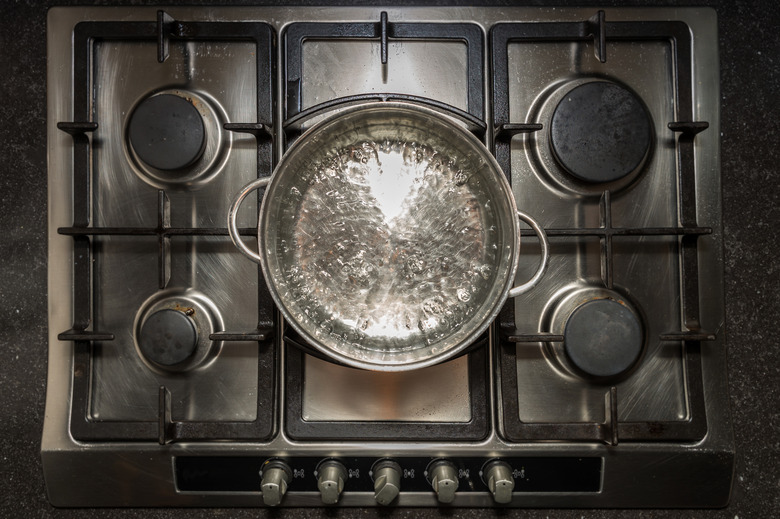 Cookingpan with boiling water on a stove, cooker