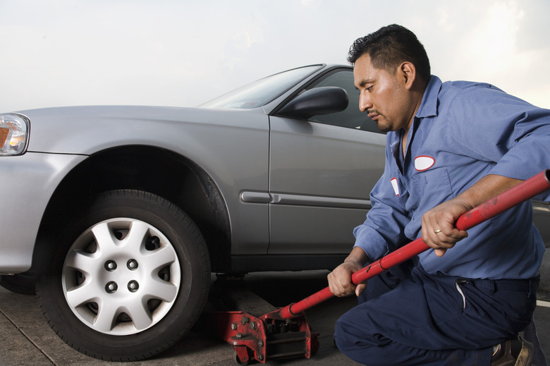 Mechanic with car and jack