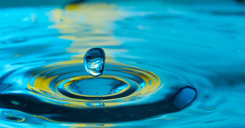 water drop in a glass of water