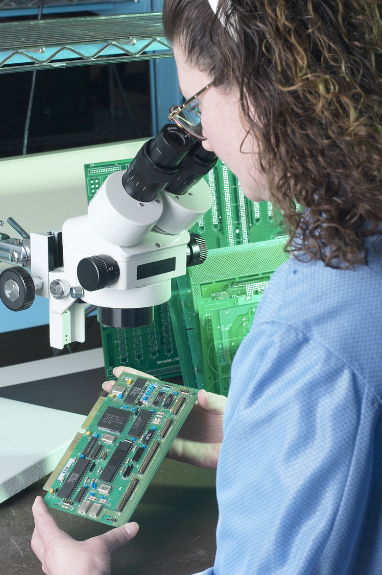 Computer technician repairing a circuit board