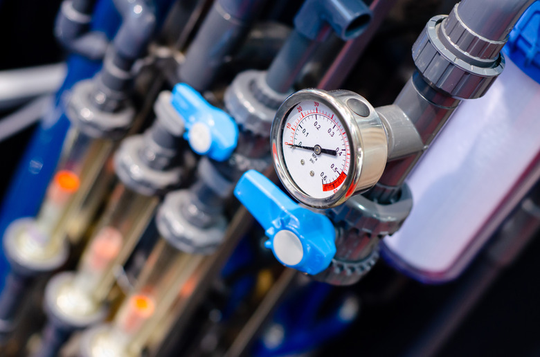 Close up of house heating system with many steel pipes, manometers and metal tubes.