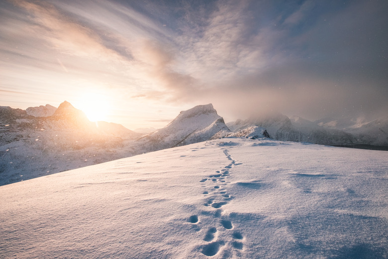 Snowy mountain ridge with footprint in blizzard