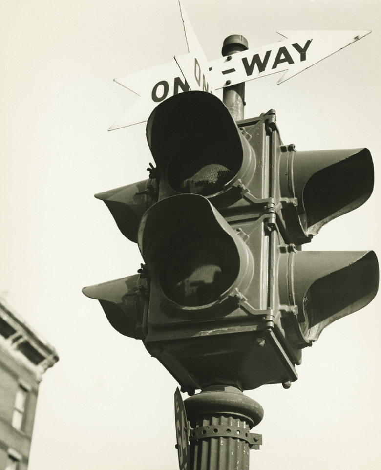 Traffic light with arrows, (B&W), low angle view