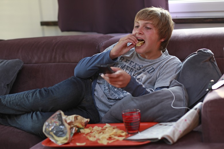 France teenager eating and watching TV