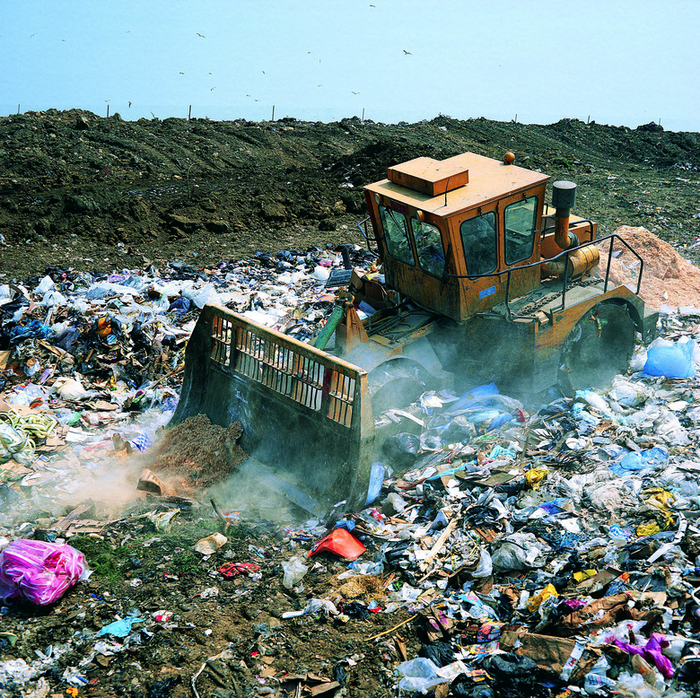 Bulldozer working on landfill site,UK