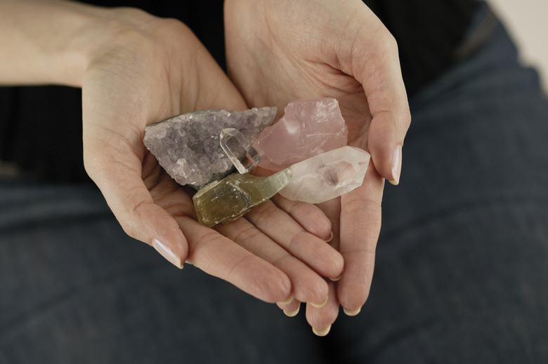 Woman holding various gemstones