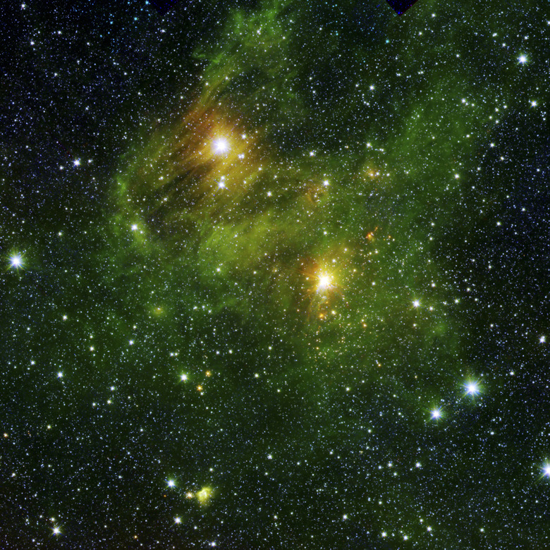 Two extremely bright stars illuminate a greenish mist in deep space.