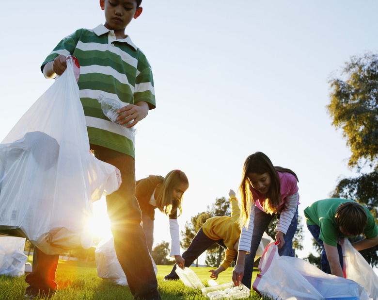 Kids Picking Up Trash in Field