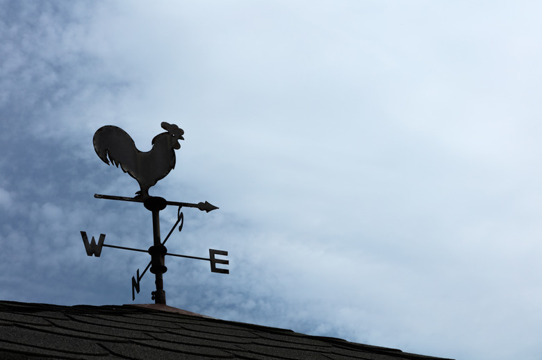 Weather Vane Silhouette against cloudy sky