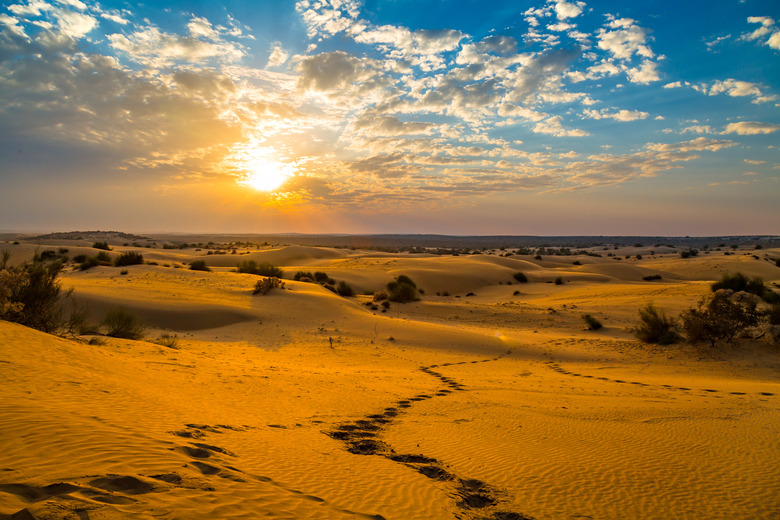 Jaisalmer Thar desert sunset Rajasthan with vibrant moody sky.