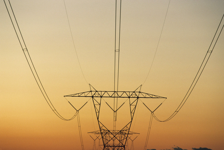 Pylon with power lines against reddish sky at sunset, Rural North Carolina, USA