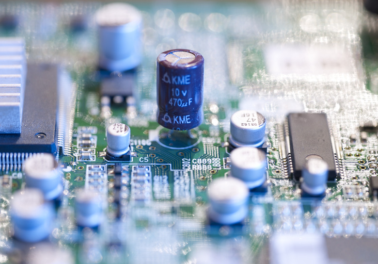 Electronic microcircuit with microchips and capacitors taken closeup