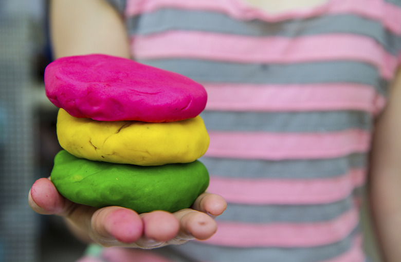 Colorful  play dough on hand