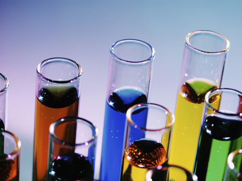 Test tubes containing colored liquid, close-up, part of