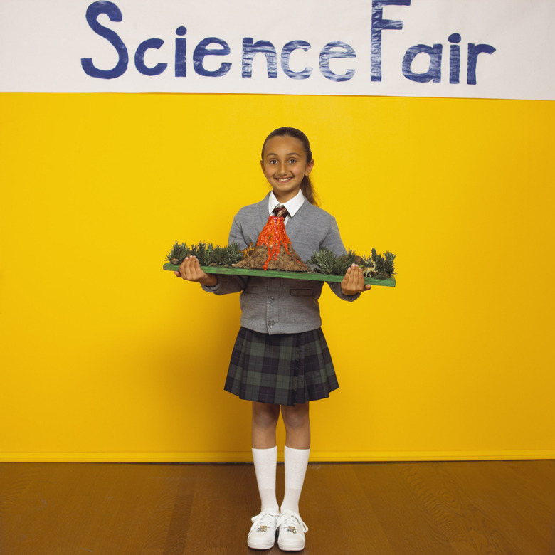 Girl holding model volcano