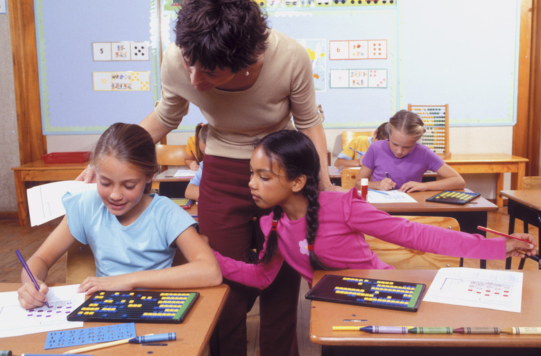 Teacher supervising girls in classroom