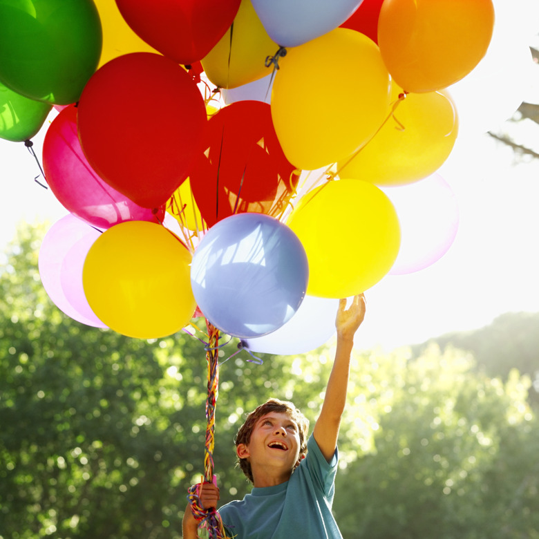 low angle view of a boy holding balloons