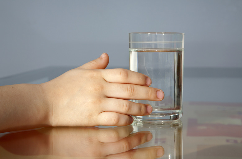 hand of child and glass