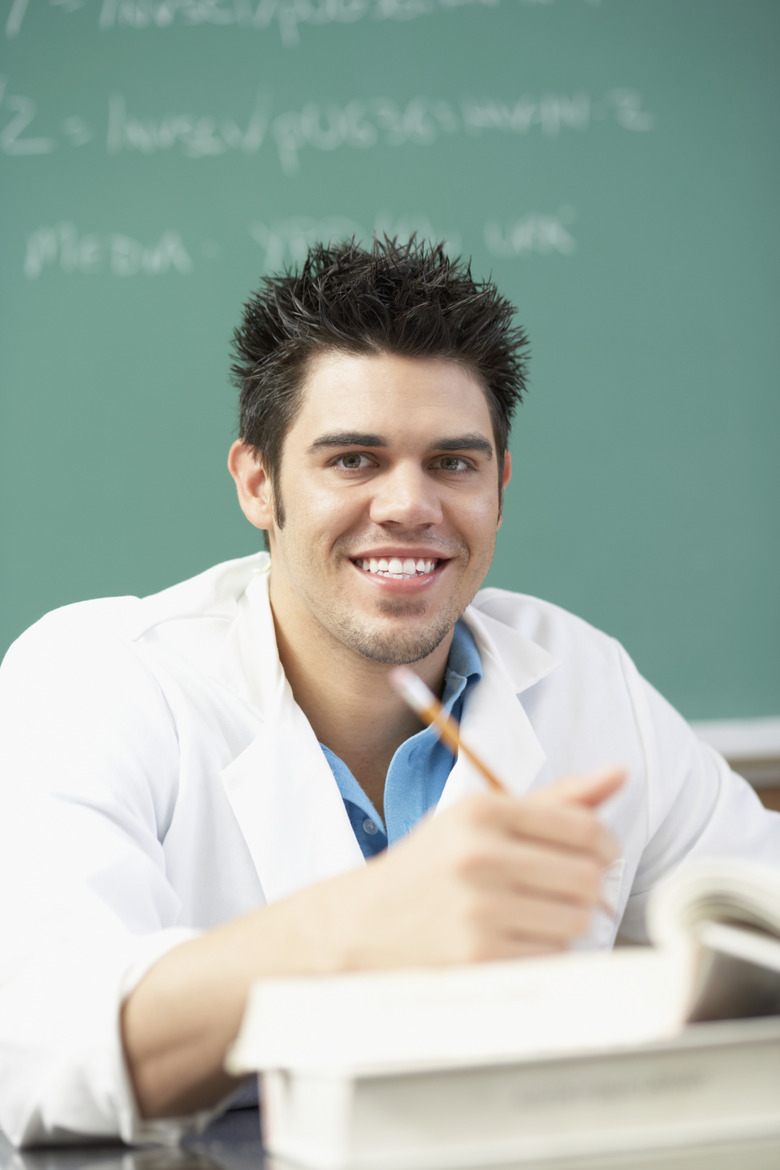 Portrait of a young man sitting in a classroom smiling