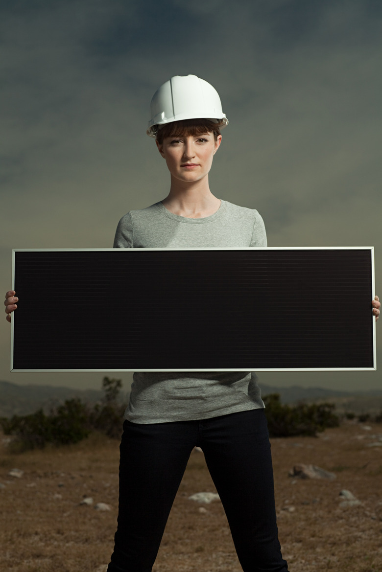 Woman holding solar panel