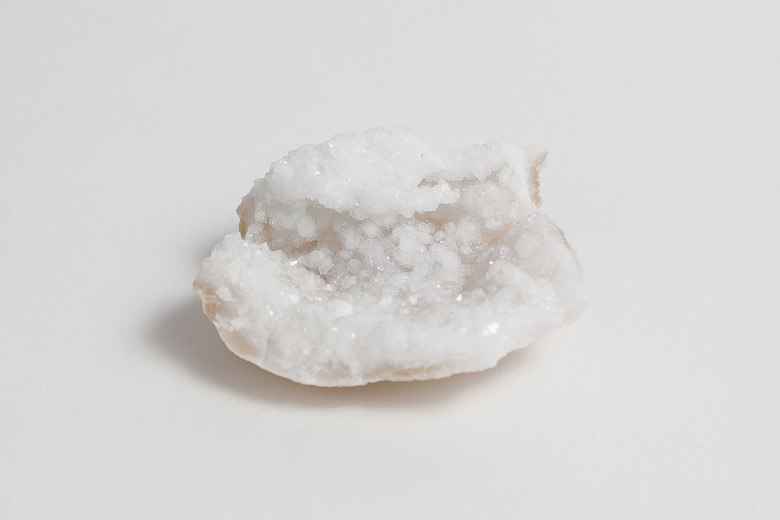 Ore milky quartz on white background.