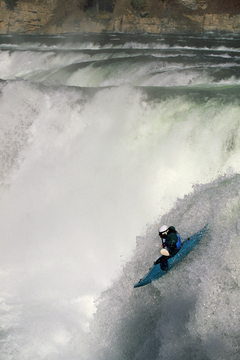 Man kayaking over Kootenai Falls