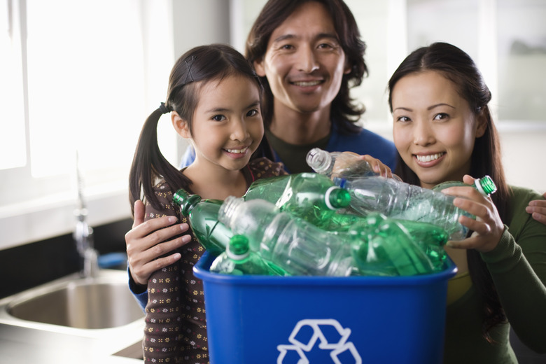 Family with recycling bin