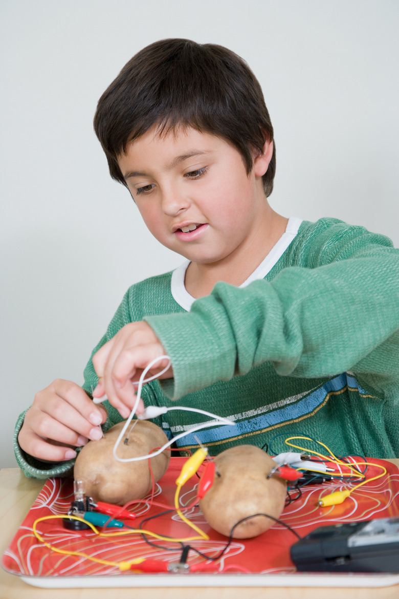 Boy making potato batteries at home