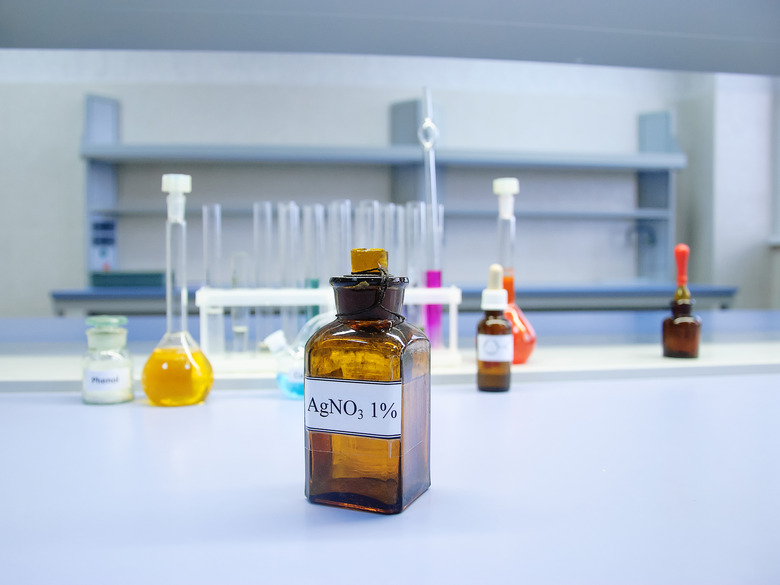 Brown glass bottle containing silver nitrate in a chemical laboratory, blurred background