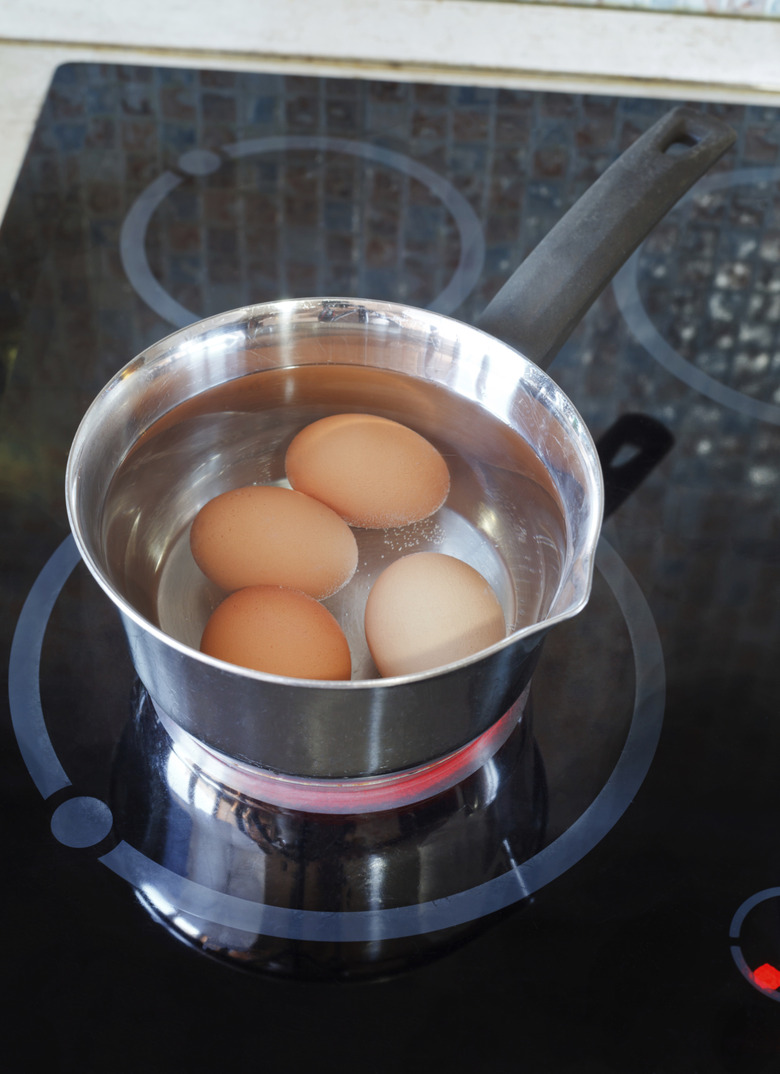 Chicken eggs are cooked in metal pot