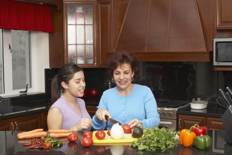 Teenage girl helping her grandmother in the kitchen