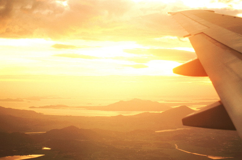 Airplane in flight at dusk, aerial view