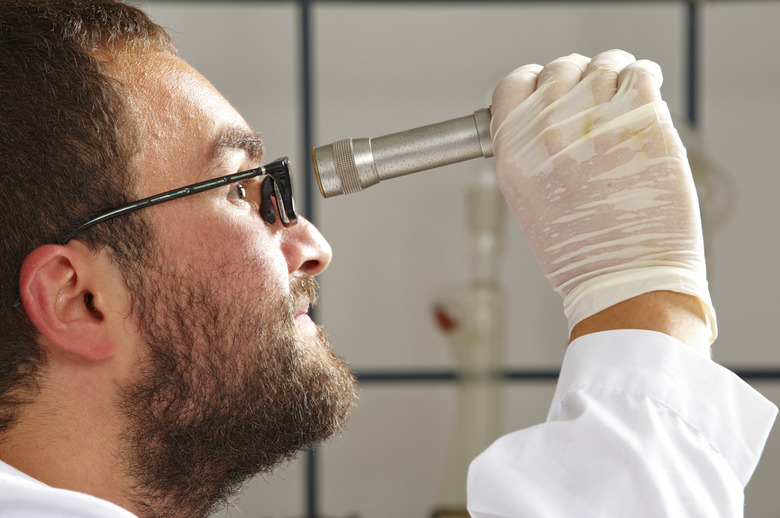 Chemist using a Refractometer