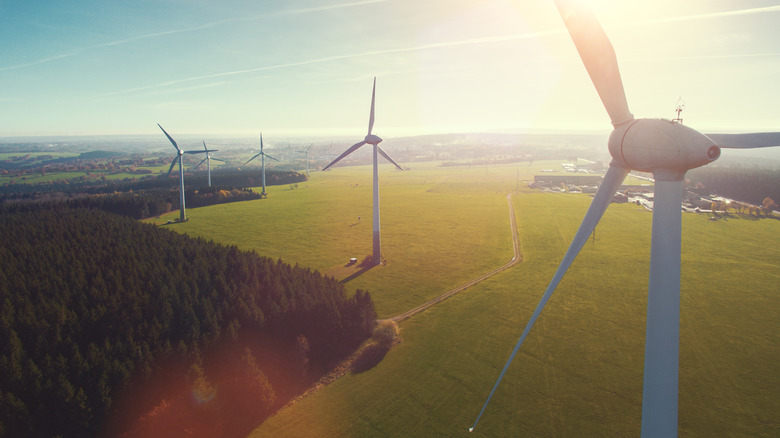 Wind Turbines On Field Against Sky