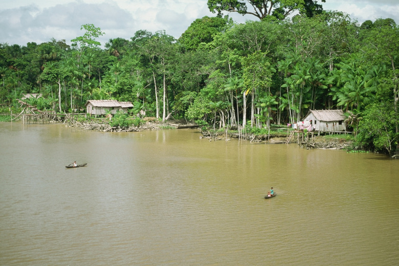 Two people canoeing on Breves Narrows on the Amazon River, Brazil