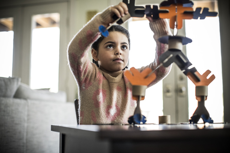 Girl building robot (7 yrs)