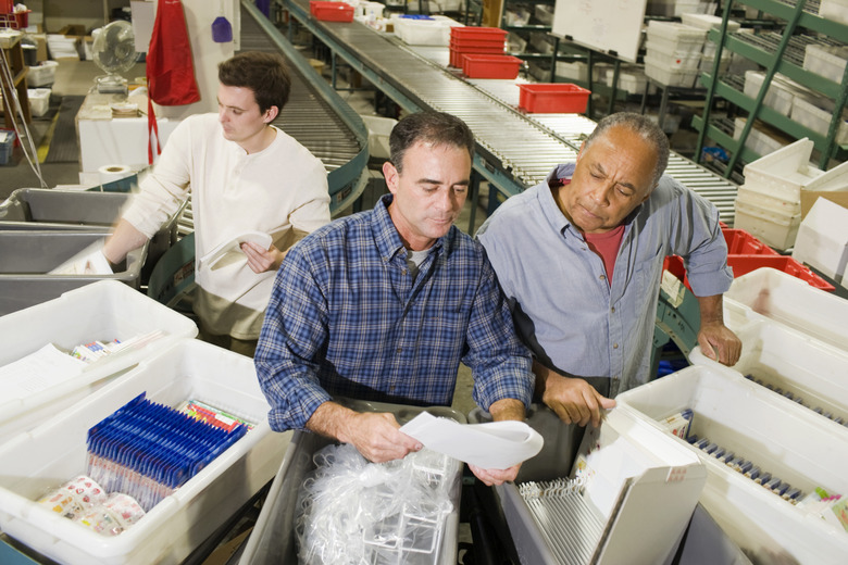 Warehouse workers inspecting packages