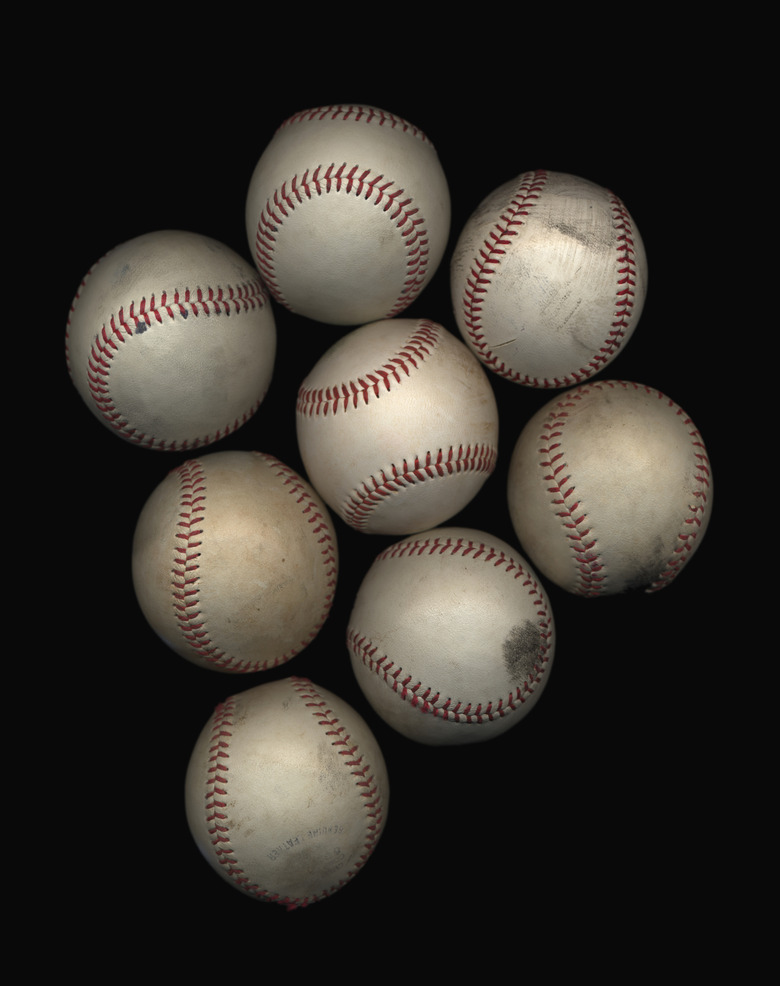 Group of old baseballs on black background