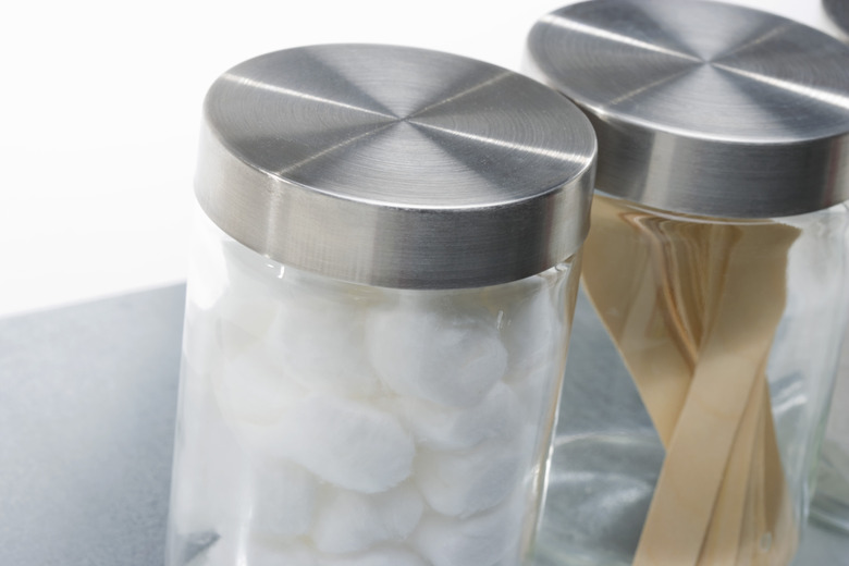 Glass canisters of cotton balls and tongue depressors