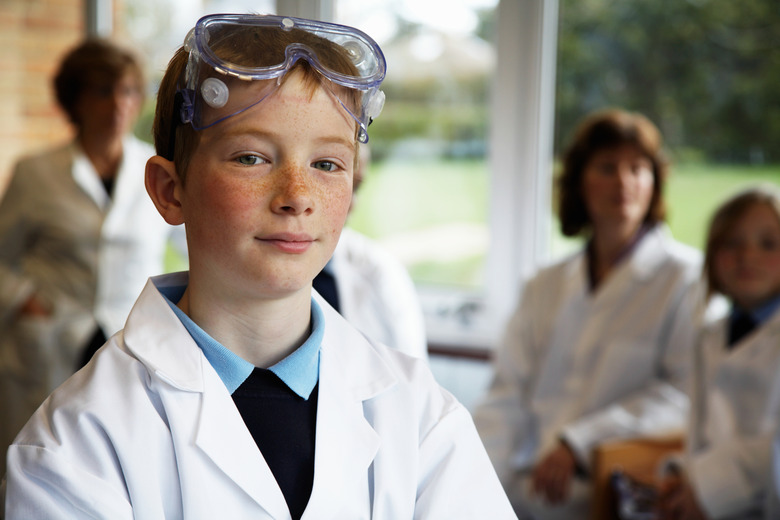 Schoolboy (11-13) in science class, smiling, portrait (focus on boy)