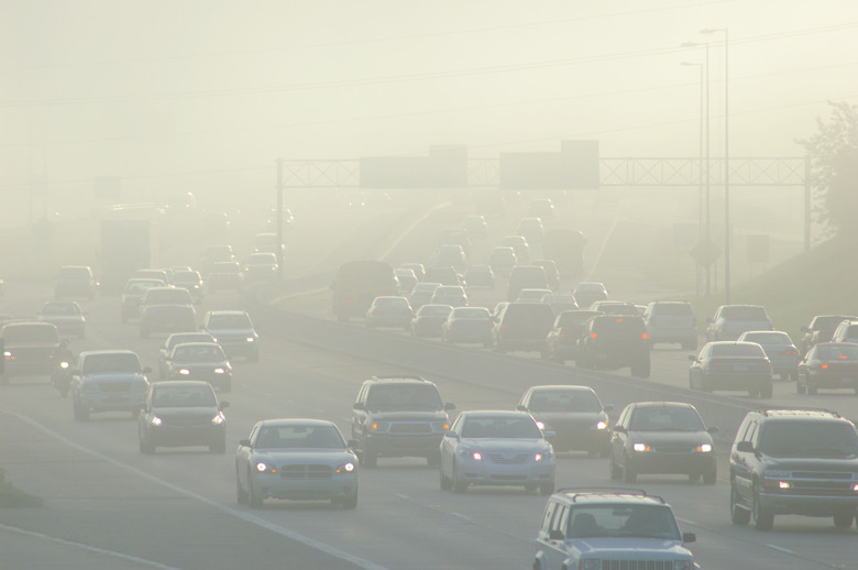 Cars at Rush Hour Driving Through Thick Smog